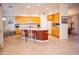 Open kitchen featuring a large island with seating, cabinetry, and tiled flooring at 7413 E Russet Sky Dr, Scottsdale, AZ 85266