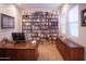 Dedicated home library with custom shelving, desk, and bright lighting at 7413 E Russet Sky Dr, Scottsdale, AZ 85266