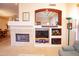 Inviting living room with fireplace, recessed display shelves, and a comfortable seating area at 7413 E Russet Sky Dr, Scottsdale, AZ 85266
