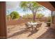Covered patio with brick pavers and an outdoor dining set with shade umbrella at 7413 E Russet Sky Dr, Scottsdale, AZ 85266