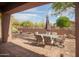 Charming patio area with tile flooring, a dining table, and views of the beautiful desert landscape at 7413 E Russet Sky Dr, Scottsdale, AZ 85266
