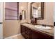 This bathroom features double sinks with framed mirrors, tiled countertops, and dark wood cabinetry at 7939 E Stonecliff Cir, Mesa, AZ 85207