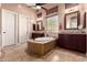 Bathroom with a soaking tub, dual vanities, and tile flooring at 7939 E Stonecliff Cir, Mesa, AZ 85207