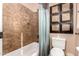 This bathroom features a tiled shower and tub, shower curtain, and a toilet, plus decorative wall art at 7939 E Stonecliff Cir, Mesa, AZ 85207