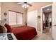 Bedroom featuring a window, ceiling fan, and closet at 7939 E Stonecliff Cir, Mesa, AZ 85207