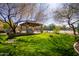 Lush green common area with a ramada, tables, and benches next to a tennis court for residents to enjoy at 7939 E Stonecliff Cir, Mesa, AZ 85207