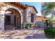 Charming courtyard with an iron gate, brick pavers, and decorative plants at 7939 E Stonecliff Cir, Mesa, AZ 85207