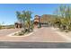 Grand entrance to gated community with lush desert landscaping and stone gatehouse, adding security and curb appeal at 7939 E Stonecliff Cir, Mesa, AZ 85207