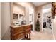 Inviting entryway featuring a wooden console table with decorative items and a large mirror, creating a warm welcome at 7939 E Stonecliff Cir, Mesa, AZ 85207