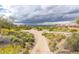 Picturesque golf course view with a walking path and storm clouds in the distance at 7939 E Stonecliff Cir, Mesa, AZ 85207