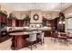 An expansive kitchen with dark cabinetry, granite countertops, and stainless steel appliances at 7939 E Stonecliff Cir, Mesa, AZ 85207