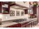 Kitchen detail featuring a gas cooktop and decorative vent hood at 7939 E Stonecliff Cir, Mesa, AZ 85207