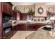 Well-equipped kitchen with granite countertops, custom cabinetry, and modern appliances, designed for culinary enthusiasts at 7939 E Stonecliff Cir, Mesa, AZ 85207