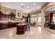 Modern kitchen with granite countertops, an island with bar seating, and ample cabinetry, perfect for cooking and entertaining at 7939 E Stonecliff Cir, Mesa, AZ 85207