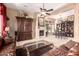 Bright and airy living room featuring a fireplace, ceiling fan, plush seating, and ample natural light at 7939 E Stonecliff Cir, Mesa, AZ 85207