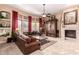 Comfortable living room features a fireplace, plush seating, and bright windows, ideal for entertaining at 7939 E Stonecliff Cir, Mesa, AZ 85207