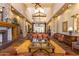 Spacious lobby featuring a fireplace, wood beams, high ceilings, and plush seating, exuding elegance at 7939 E Stonecliff Cir, Mesa, AZ 85207