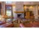 Inviting lobby sitting area with a stone fireplace and natural light at 7939 E Stonecliff Cir, Mesa, AZ 85207