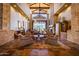 Spacious lobby with high ceilings, stone fireplace, and comfortable seating at 7939 E Stonecliff Cir, Mesa, AZ 85207