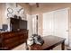 Home office featuring a dresser and a dark wooden desk at 7939 E Stonecliff Cir, Mesa, AZ 85207