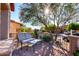 Front patio with brick flooring, wrought iron railing, and view of the neighborhood at 7939 E Stonecliff Cir, Mesa, AZ 85207