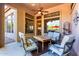 Cozy covered patio features cushioned seating, a ceiling fan, and outdoor living space at 7939 E Stonecliff Cir, Mesa, AZ 85207