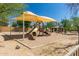 Community playground with slide, climbing structure, and shaded seating area at 7939 E Stonecliff Cir, Mesa, AZ 85207