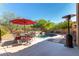 This backyard has a beautiful pool with a rock waterfall, patio with seating, desert plants and outdoor lighting at 7939 E Stonecliff Cir, Mesa, AZ 85207