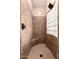 Tiled shower featuring a built-in seat and glass block window, creating a serene and stylish space at 7939 E Stonecliff Cir, Mesa, AZ 85207