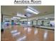 Spacious aerobics room featuring mirrored walls and hardwood floors for fitness activities at 8426 W Utopia Rd, Peoria, AZ 85382