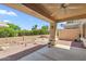 Covered patio offers a shady retreat with a decorative gravel and brick landscape at 8426 W Utopia Rd, Peoria, AZ 85382