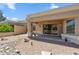 Covered patio with ceiling fan overlooking a rock and desert landscaped backyard at 8426 W Utopia Rd, Peoria, AZ 85382