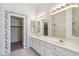 Bright bathroom with a double vanity, large mirror, and decorative border at 8426 W Utopia Rd, Peoria, AZ 85382
