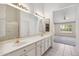 Well-lit bathroom features a double sink vanity and access to the bedroom at 8426 W Utopia Rd, Peoria, AZ 85382