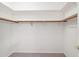 Spacious walk-in closet with ample shelving and carpeted floor at 8426 W Utopia Rd, Peoria, AZ 85382