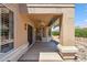 Relaxing covered patio with ceiling fan, leading to a landscaped backyard at 8426 W Utopia Rd, Peoria, AZ 85382