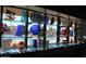 Stunning display case featuring unique glass art with a view of the community pool in the background at 8426 W Utopia Rd, Peoria, AZ 85382