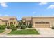 Beige single-story home featuring a manicured lawn and desert landscaping at 8426 W Utopia Rd, Peoria, AZ 85382