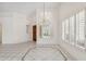 Bright foyer featuring tile flooring, chandelier, and window with shutters at 8426 W Utopia Rd, Peoria, AZ 85382