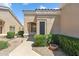 Beige single-story home featuring a covered front entrance and desert landscaping at 8426 W Utopia Rd, Peoria, AZ 85382