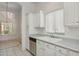 Bright kitchen featuring white cabinetry, stainless steel appliances, and a window with natural light at 8426 W Utopia Rd, Peoria, AZ 85382