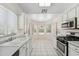 Bright kitchen featuring white cabinetry, stainless steel appliances, and a breakfast nook at 8426 W Utopia Rd, Peoria, AZ 85382