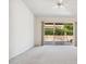 Living room featuring light colored carpet, ceiling fan and sliding door to backyard at 8426 W Utopia Rd, Peoria, AZ 85382