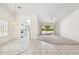 Bright living room featuring tile flooring, chandelier, and kitchen access at 8426 W Utopia Rd, Peoria, AZ 85382