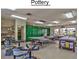 Well-equipped pottery studio with various tables, tools, and supplies, providing residents a creative space for crafting at 8426 W Utopia Rd, Peoria, AZ 85382