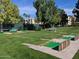 Scenic putting green with lush grass and a tranquil setting surrounded by mature trees and well maintained landscaping at 8426 W Utopia Rd, Peoria, AZ 85382