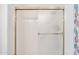 A white shower with glass doors and gold trim at 8426 W Utopia Rd, Peoria, AZ 85382