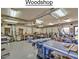Brightly lit woodshop featuring multiple workstations and an array of tools for various woodworking projects at 8426 W Utopia Rd, Peoria, AZ 85382