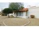 Single-story home with desert landscaping, including decorative rock and mature trees at 8626 E Irish Hunter Trl, Scottsdale, AZ 85258