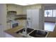 Bright kitchen featuring white cabinets and appliances, and laminate countertops at 8626 E Irish Hunter Trl, Scottsdale, AZ 85258